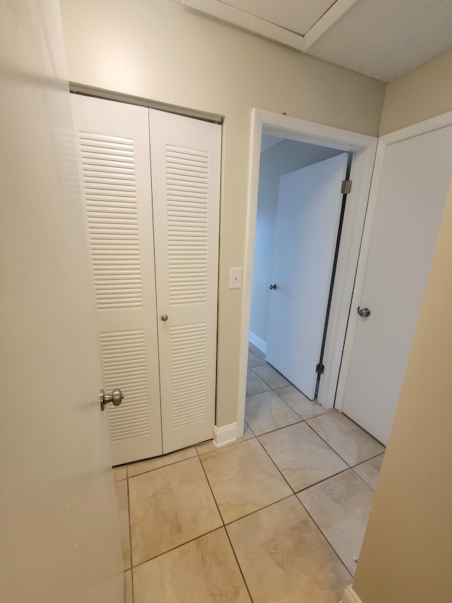 hallway featuring light tile patterned flooring