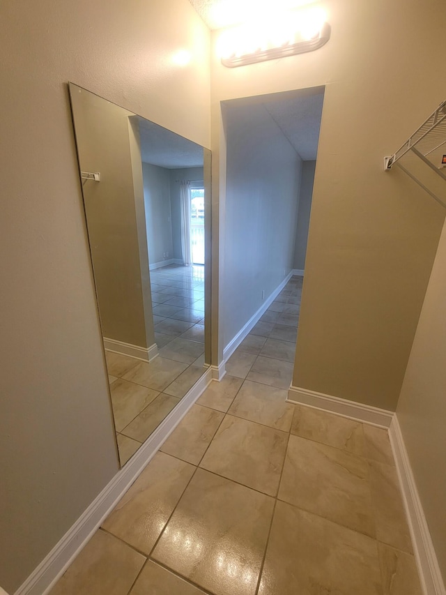 hall featuring light tile patterned flooring