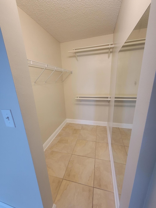 walk in closet with tile patterned flooring