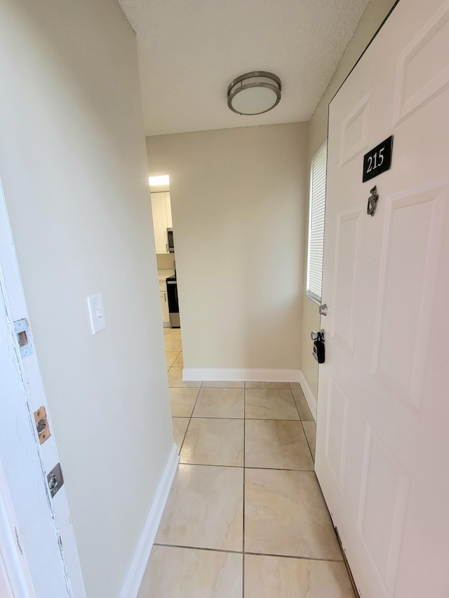 hallway with light tile patterned floors