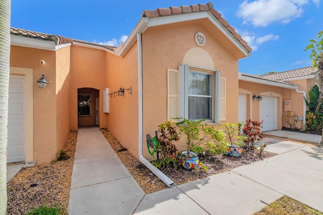 view of exterior entry with a garage