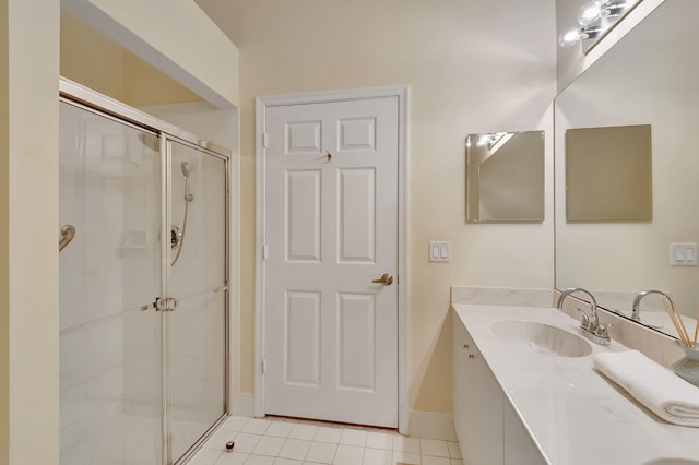 bathroom featuring tile patterned flooring, vanity, and a shower with shower door