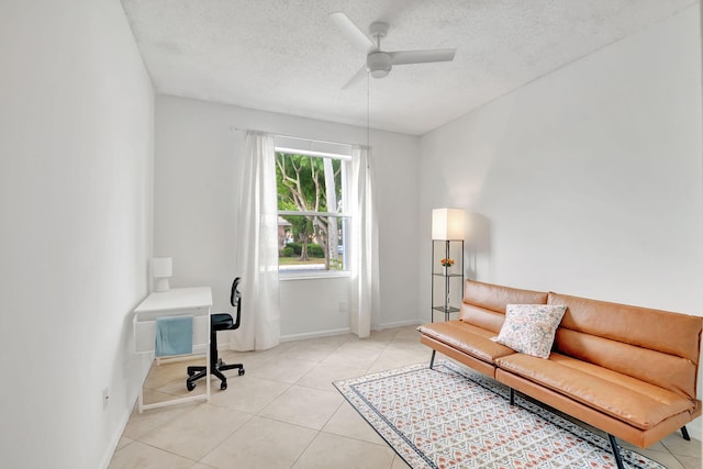 tiled office featuring ceiling fan and a textured ceiling