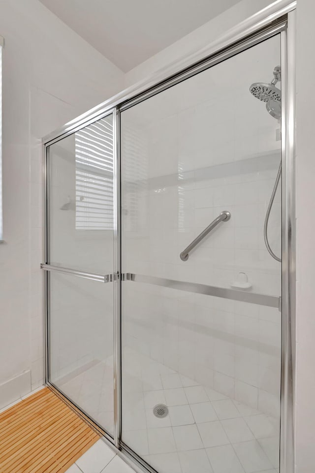 bathroom featuring a shower with door