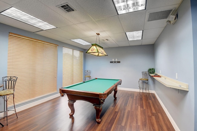 game room with a drop ceiling, dark wood-type flooring, and billiards