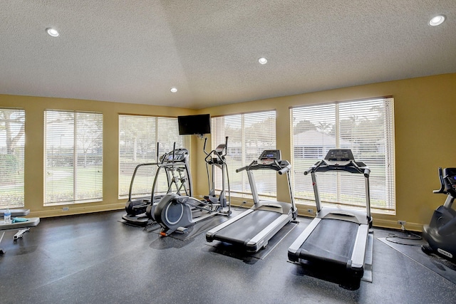 exercise area with a textured ceiling and a healthy amount of sunlight