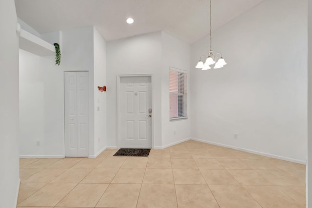 entrance foyer featuring a chandelier, high vaulted ceiling, and light tile patterned flooring