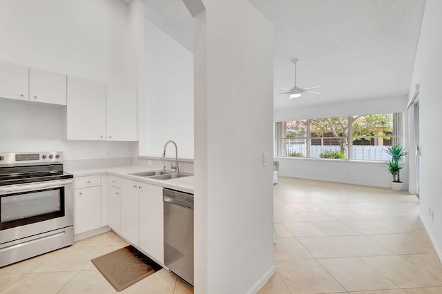 kitchen featuring white cabinets, light tile patterned flooring, sink, and appliances with stainless steel finishes