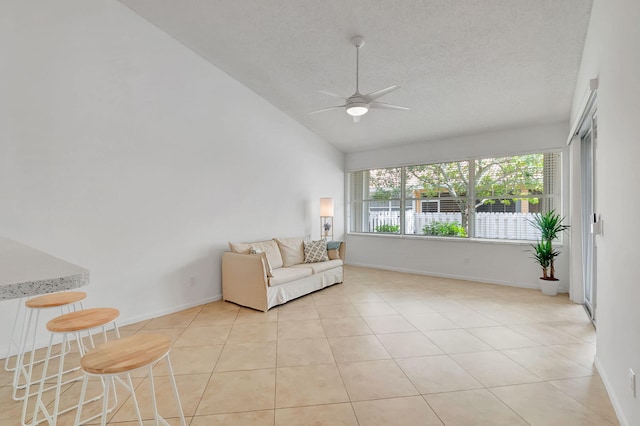 unfurnished living room featuring ceiling fan, lofted ceiling, a textured ceiling, and light tile patterned floors