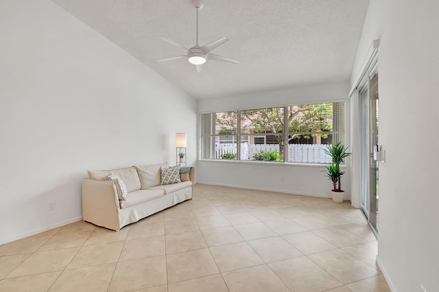 interior space with a textured ceiling, high vaulted ceiling, ceiling fan, and light tile patterned flooring