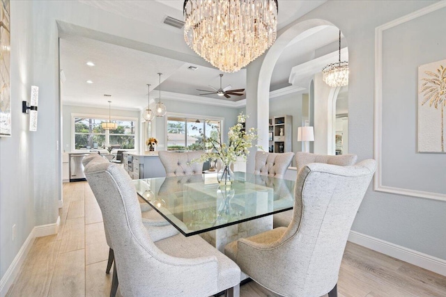 dining space featuring ceiling fan, crown molding, and light hardwood / wood-style flooring