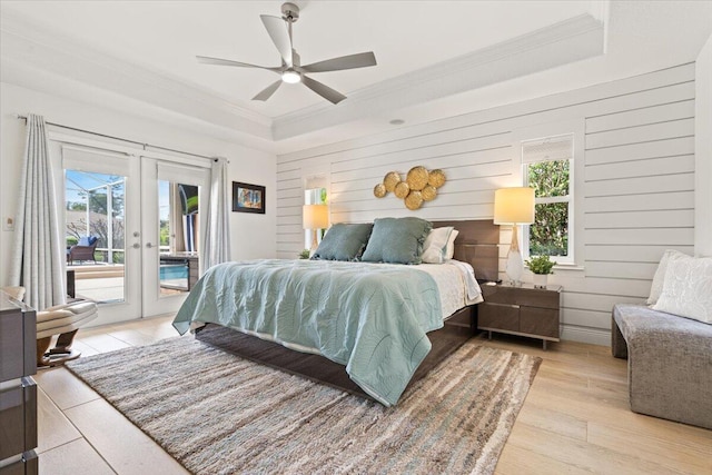 bedroom featuring multiple windows, ceiling fan, french doors, and access to exterior