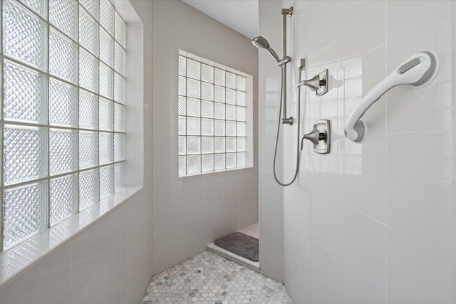 bathroom with a tile shower