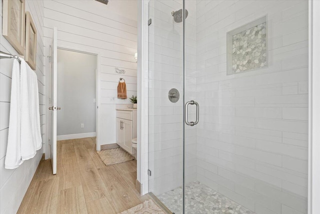 bathroom featuring vanity, hardwood / wood-style flooring, and an enclosed shower