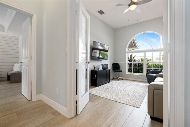 living room with ceiling fan and light hardwood / wood-style flooring