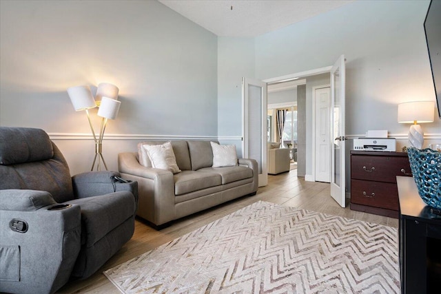 living room featuring light hardwood / wood-style flooring and lofted ceiling