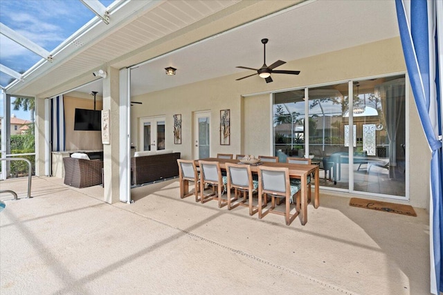 view of patio featuring glass enclosure and ceiling fan