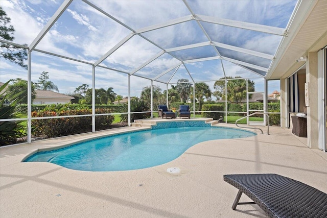 view of swimming pool with glass enclosure and a patio area