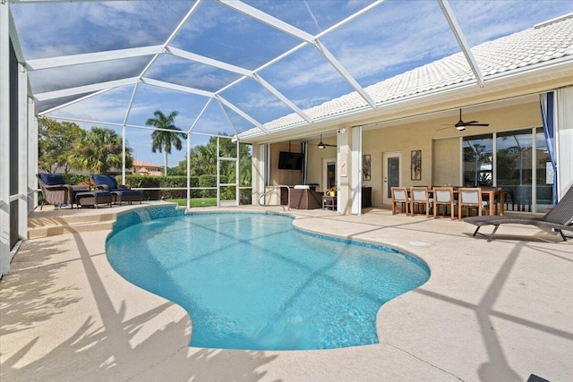 view of swimming pool with ceiling fan, a patio area, and an outdoor bar