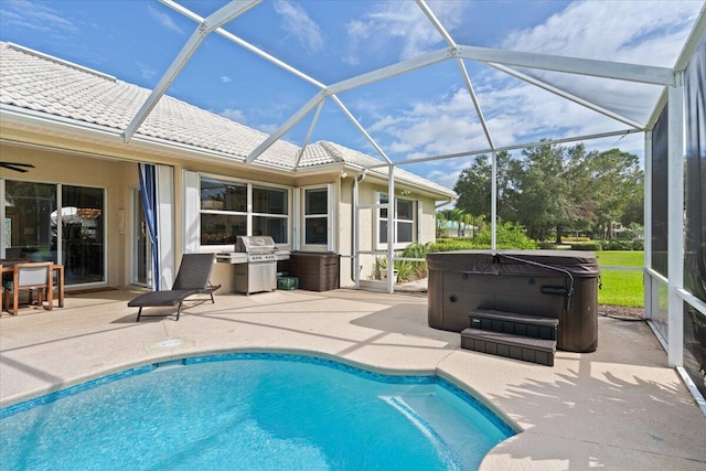 view of pool with glass enclosure, area for grilling, a patio area, and a hot tub