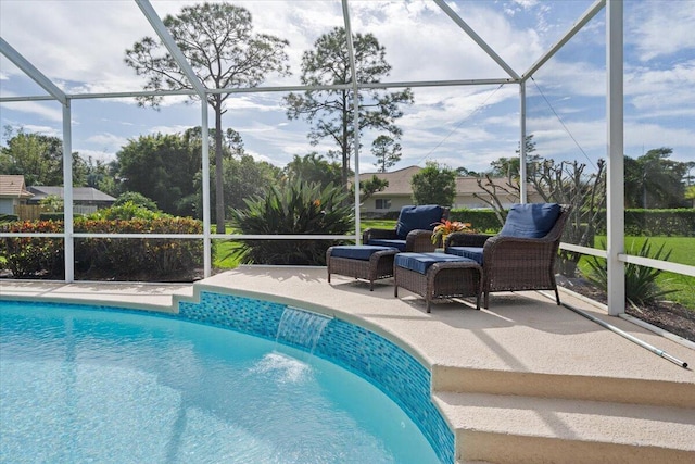 view of pool with a lanai, a patio area, and pool water feature