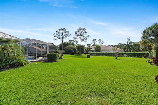 view of yard featuring glass enclosure