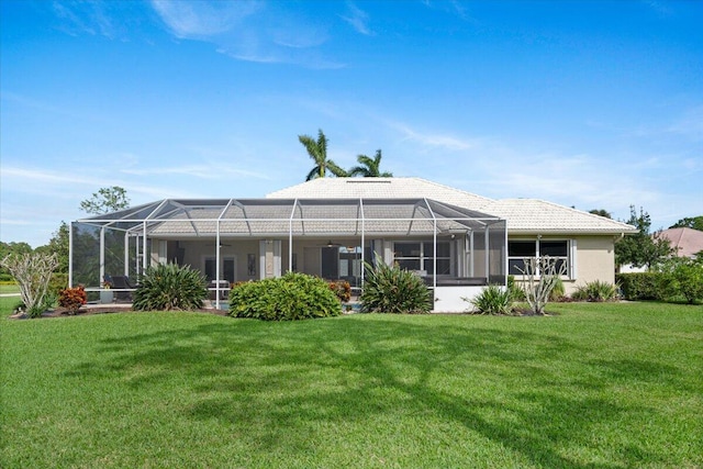 back of property with a yard and a lanai