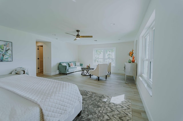 bedroom with ceiling fan and light hardwood / wood-style flooring