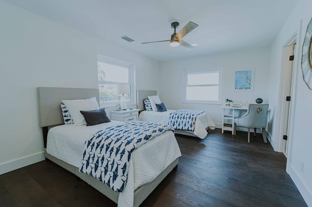 bedroom featuring multiple windows, ceiling fan, and dark wood-type flooring