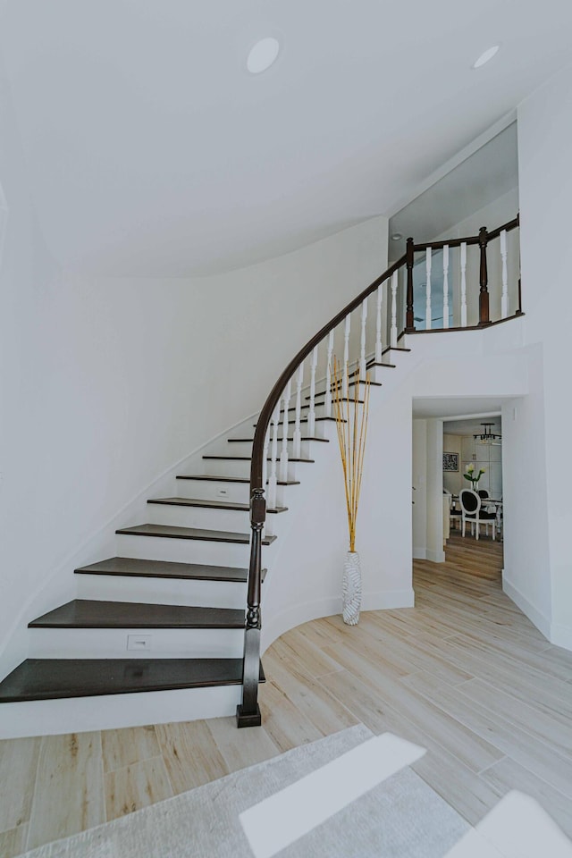 stairway featuring wood-type flooring