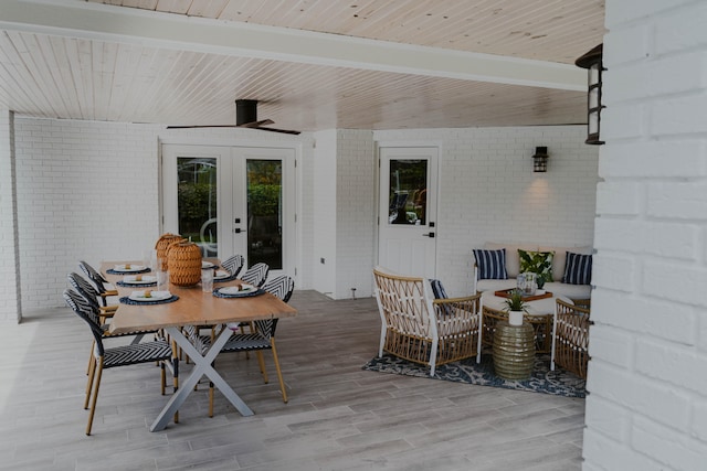 wooden deck with french doors and an outdoor living space