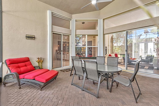 sunroom / solarium featuring ceiling fan and lofted ceiling