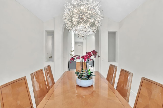 dining room with vaulted ceiling and a notable chandelier