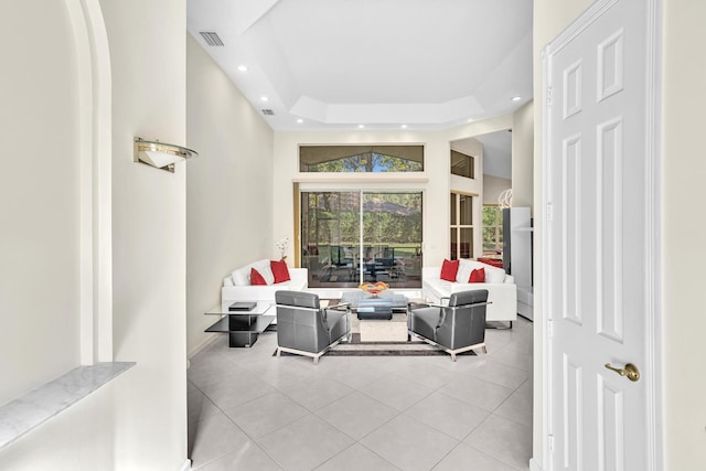 tiled living room with a tray ceiling