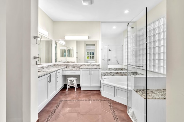 bathroom with vanity, tile patterned floors, and independent shower and bath