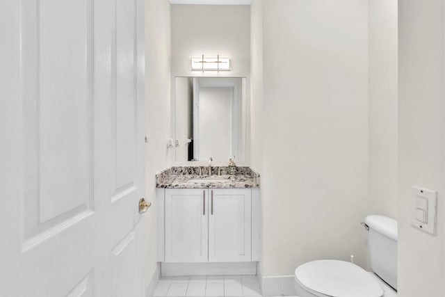 bathroom with tile patterned flooring, vanity, and toilet