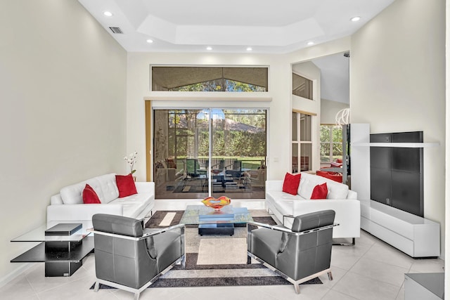 tiled living room featuring a towering ceiling