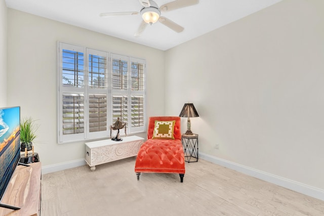 sitting room featuring ceiling fan and light hardwood / wood-style flooring