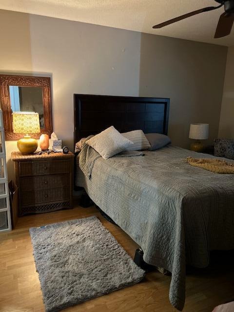 bedroom with light hardwood / wood-style flooring and ceiling fan