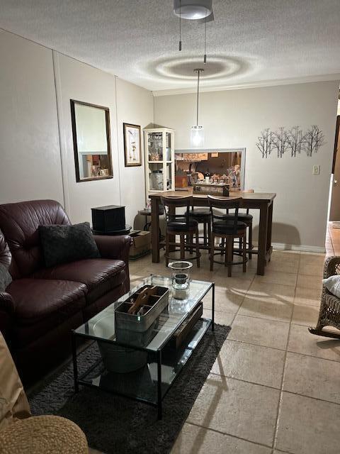 living room with light tile patterned floors and a textured ceiling