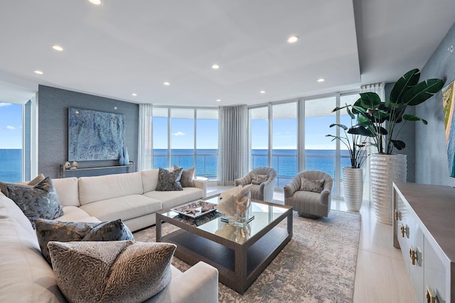 living room with floor to ceiling windows and a water view