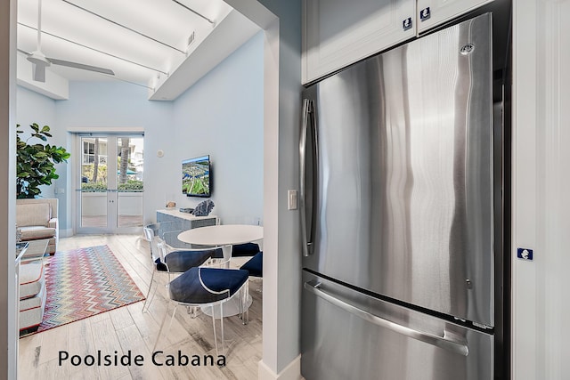 kitchen featuring hardwood / wood-style flooring, ceiling fan, stainless steel refrigerator, and french doors