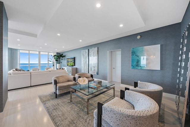 living room featuring floor to ceiling windows and a water view