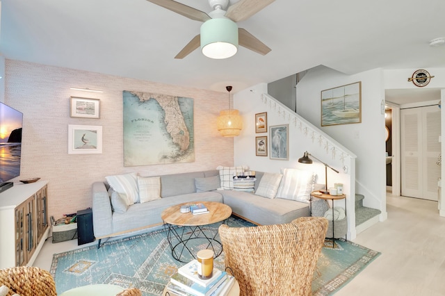 living room with ceiling fan and light hardwood / wood-style flooring