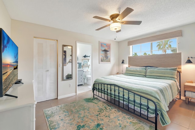 tiled bedroom featuring ensuite bath, ceiling fan, a closet, and a textured ceiling