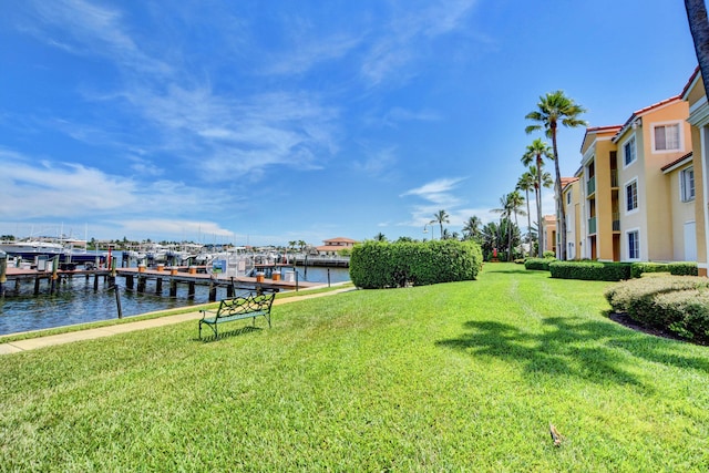 dock area with a yard and a water view