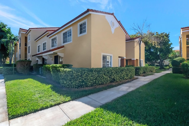 view of home's exterior with a lawn