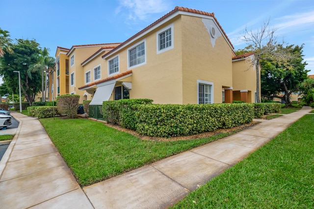 view of property exterior with a yard