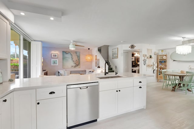 kitchen with dishwasher, white cabinetry, sink, and hanging light fixtures