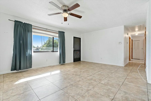 spare room featuring ceiling fan and a textured ceiling